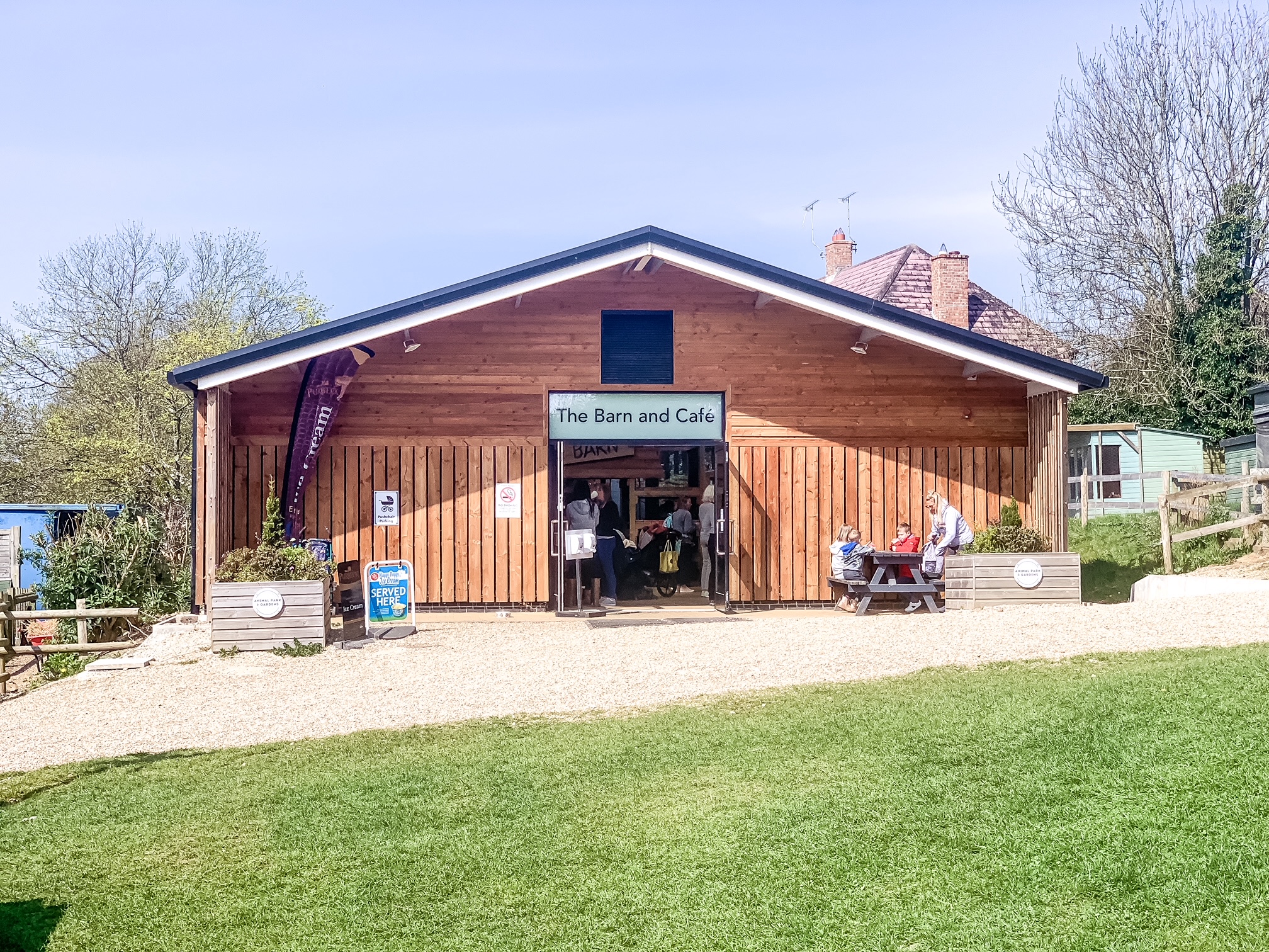 Kingston Maurward Animal Park and Gardens - Large wooden structure with 'The Barn & Cafe' outside